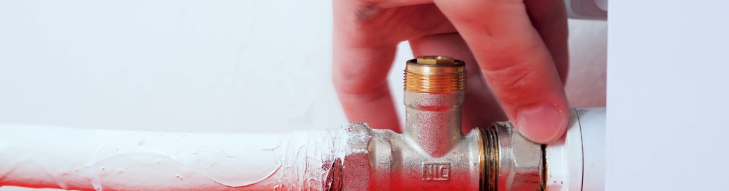 Plumber Removing Pipes To Remove Radiator Off The Wall 
