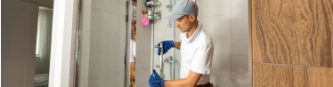 Plumber Fixing In Shower To Bathroom Enclosure