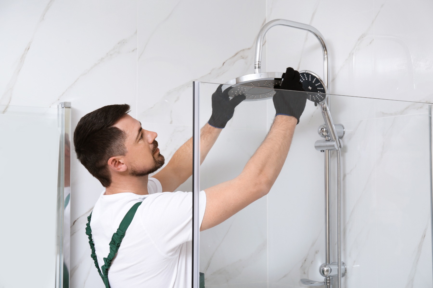 Plumber Fitting Showerhead Into Newly Built Enclosure