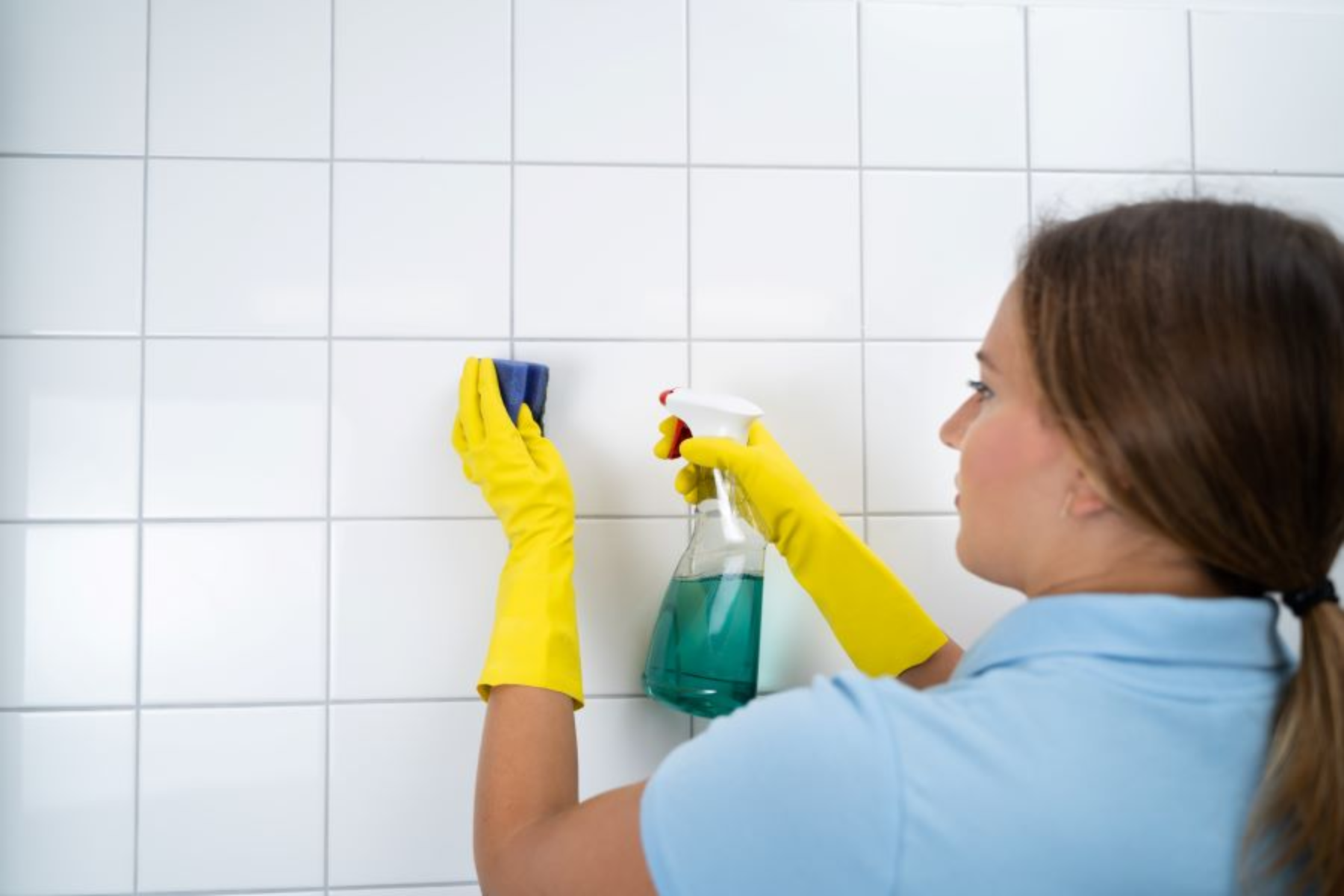 Cleaner Cleaning White Tiles In Bathroom