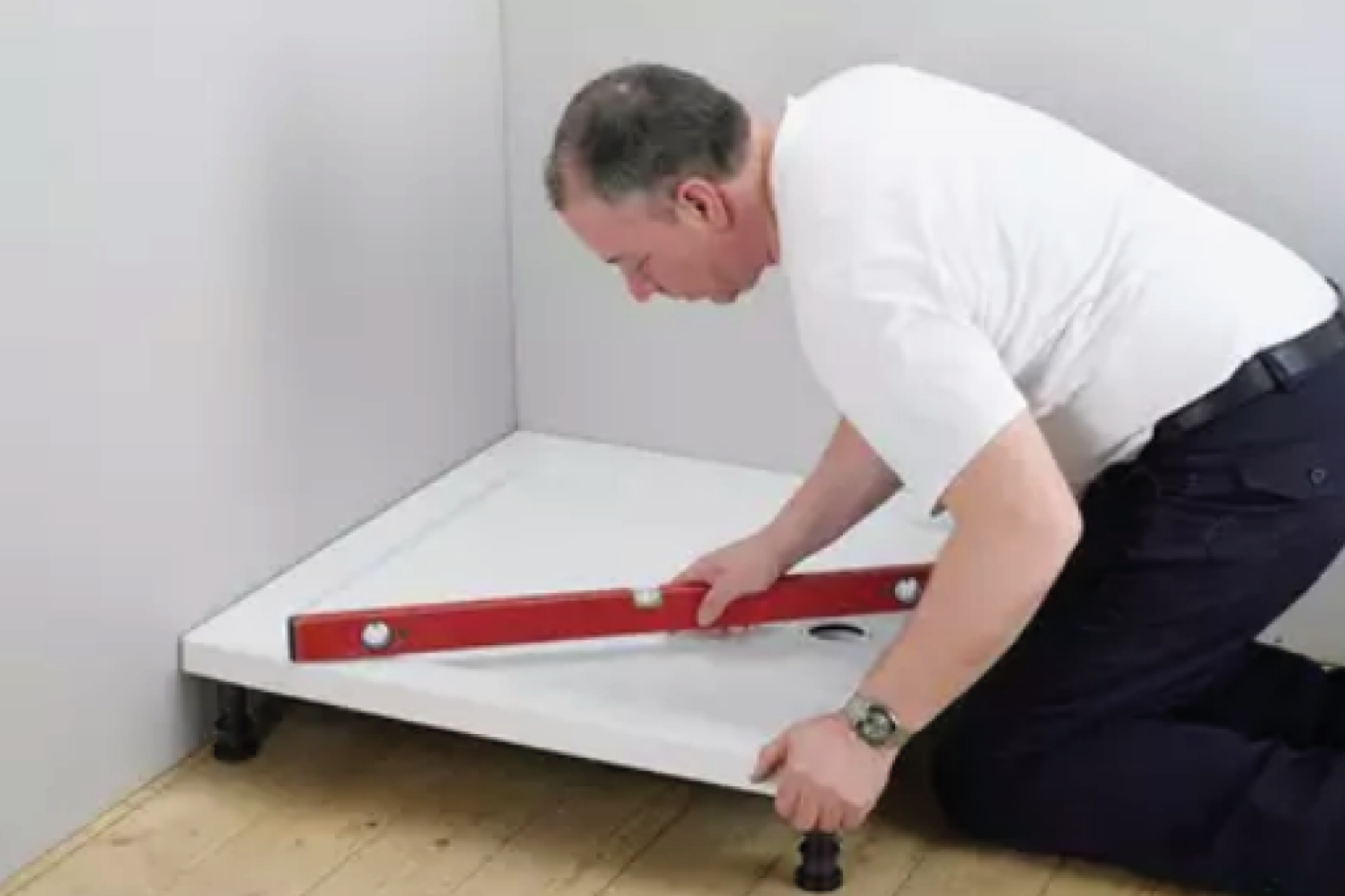Man Measuring Shower Tray In Bathroom Before Fitting
