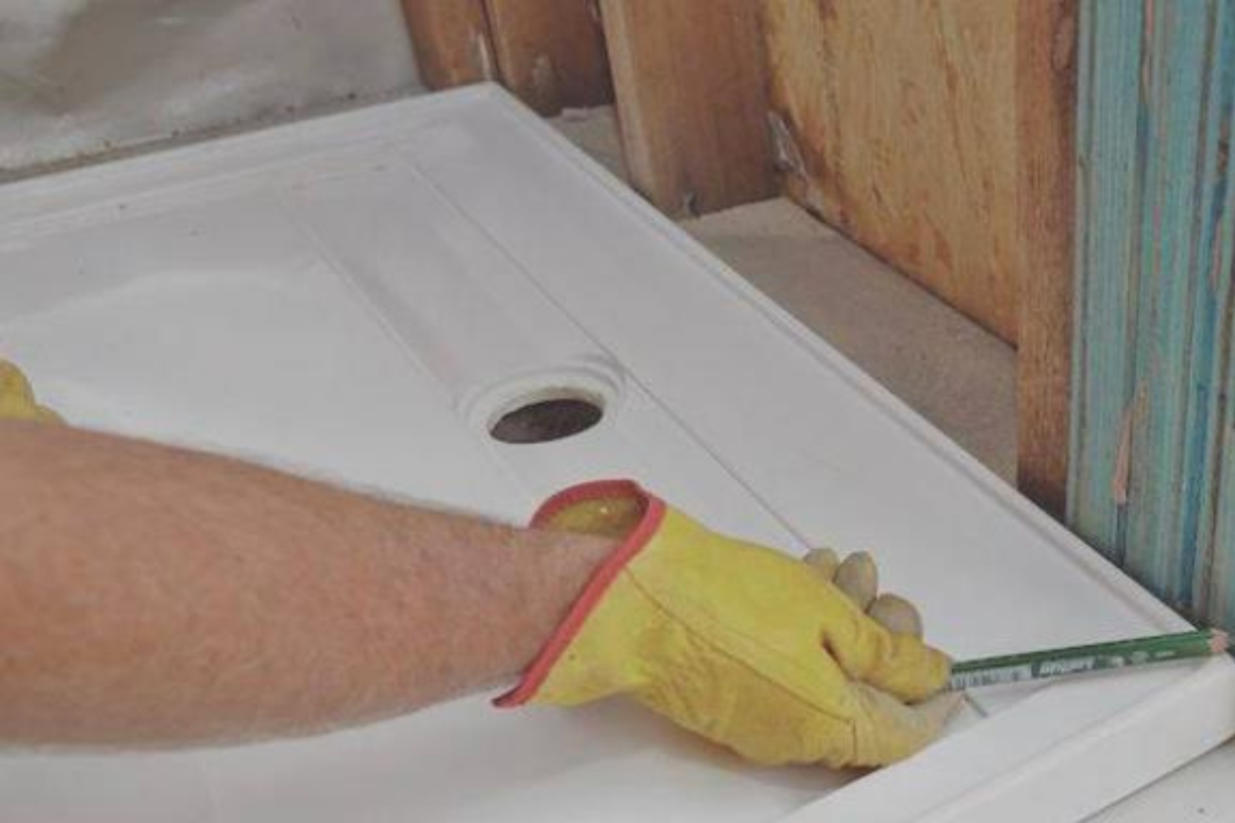 Low Profile Shower Tray Getting Measured Up By Plumber